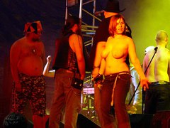 Chubby girl exposing her tits on the scene. Image 1