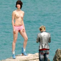 Posing naked on the beach