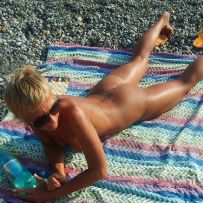 Posing naked on the beach